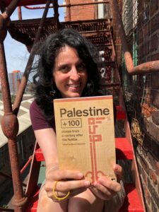Editor Basma Ghalayini holds a copy of "Palestine +100"
